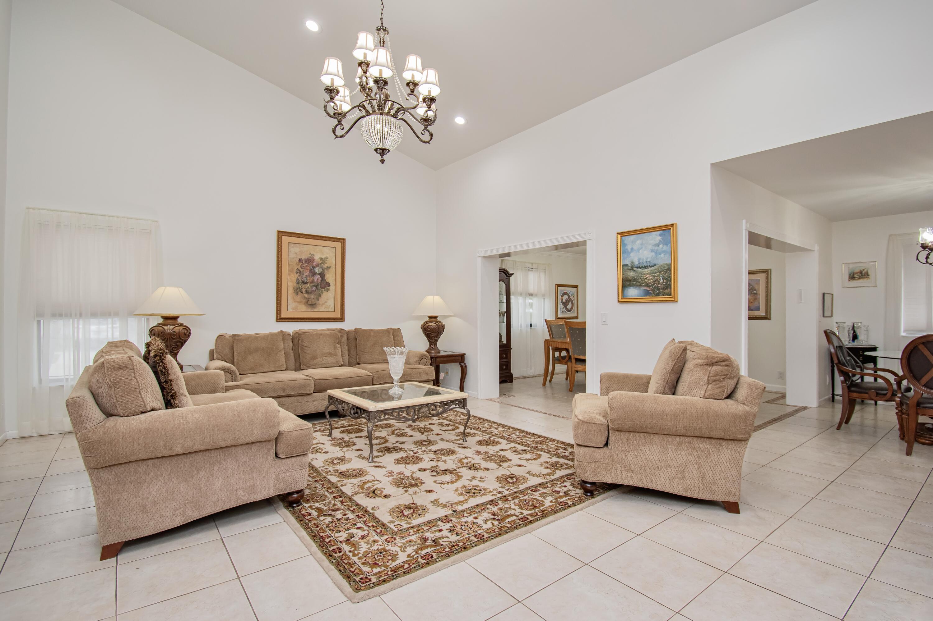 7838 Cypress Crescent Boca Raton, FL 33433 - Photo 3 of 24 a living room with furniture and a chandelier
