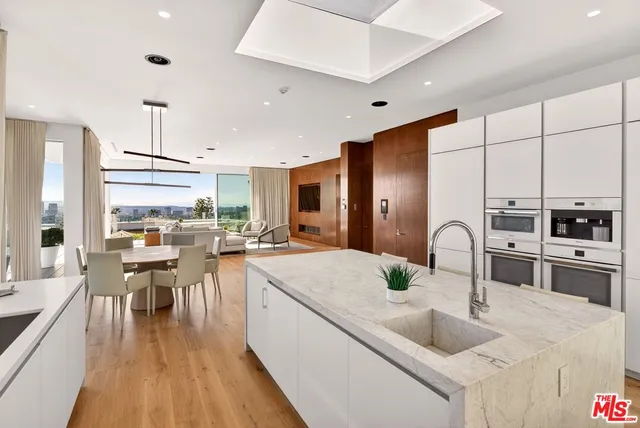 a bedroom with a large window and a bed