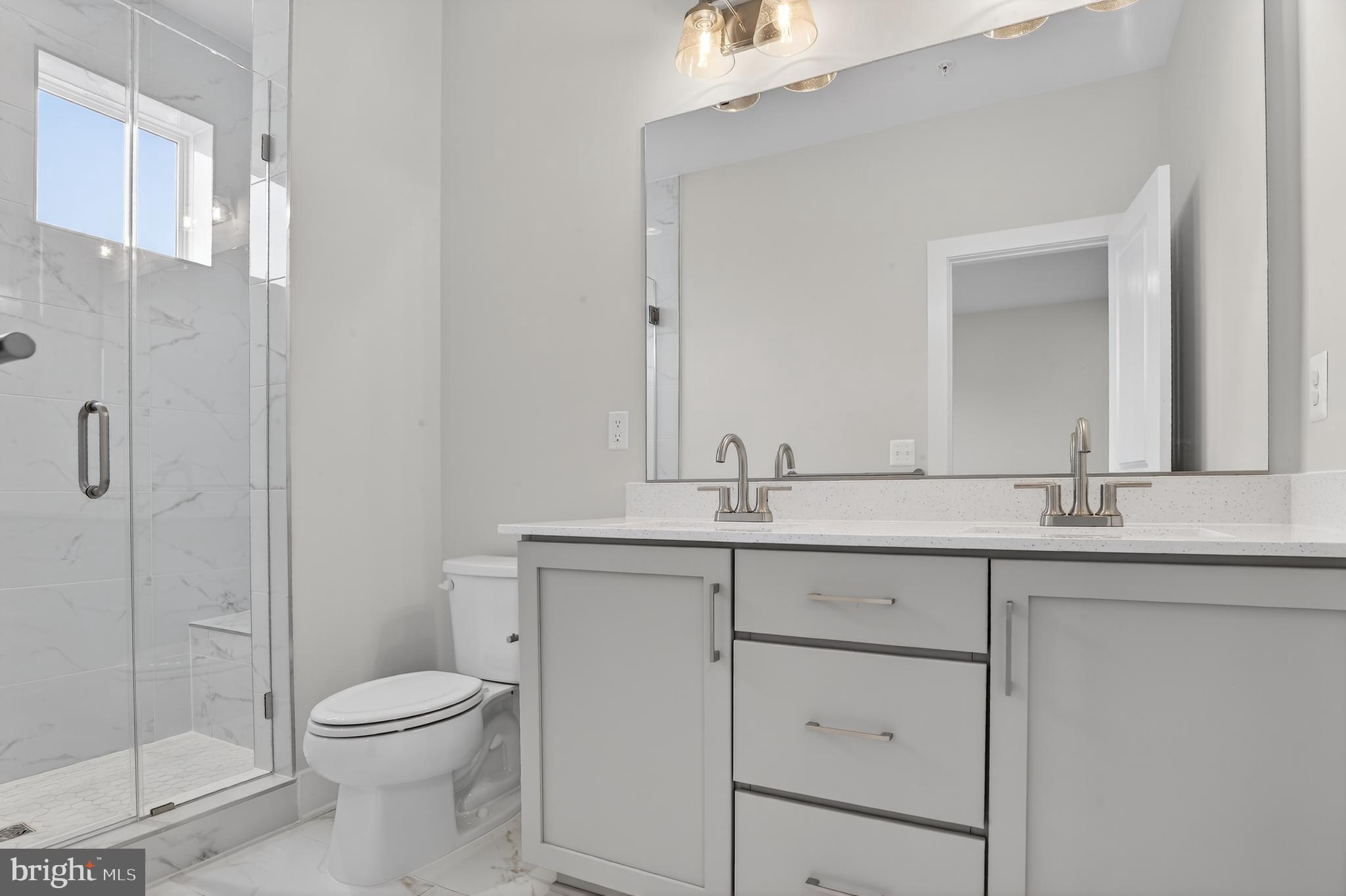 2710 Light Street Baltimore, MD 21230 - Photo 12 of 25 a bathroom with a toilet sink and shower