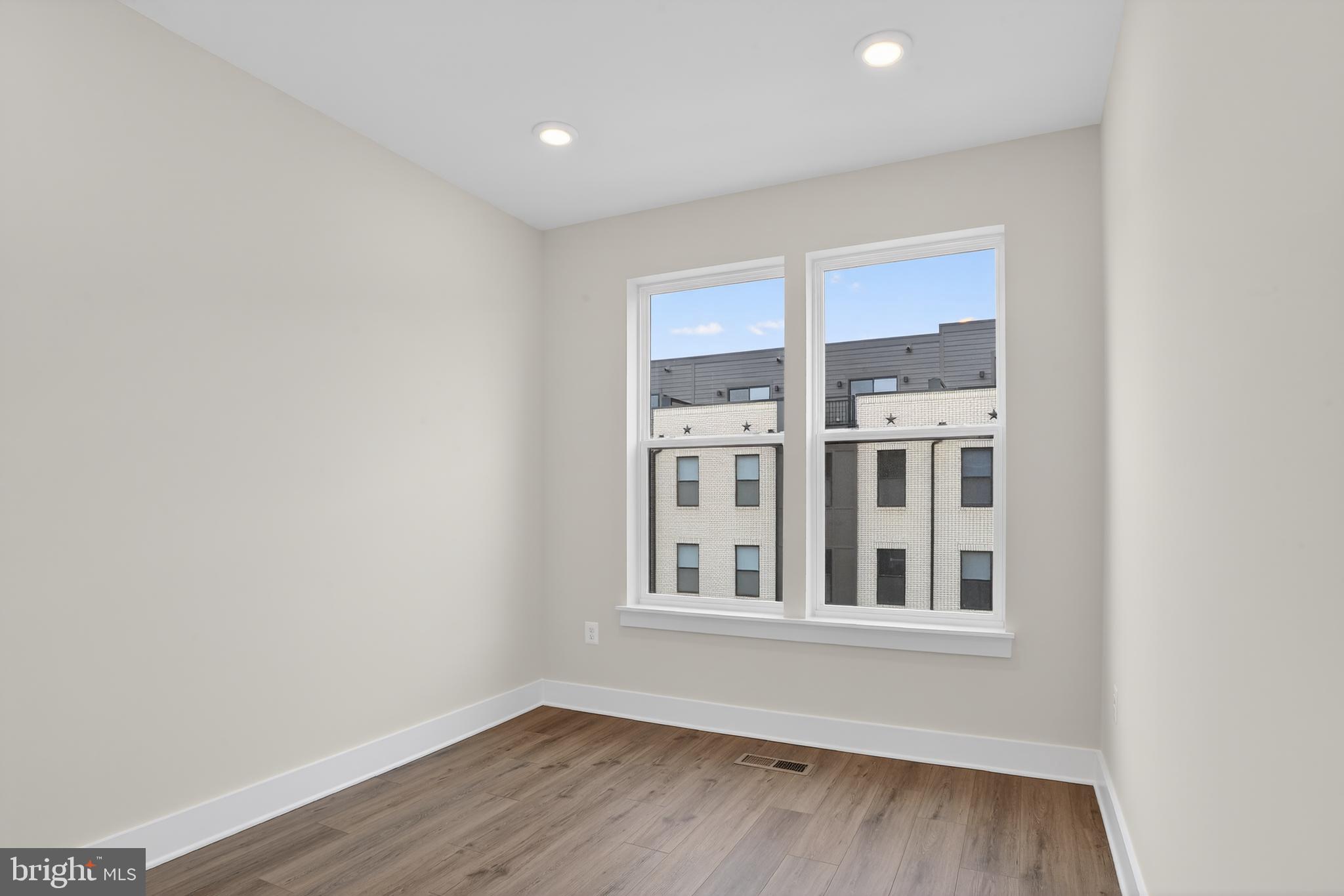 2710 Light Street Baltimore, MD 21230 - Photo 13 of 25 a view of an empty room with wooden floor and a window
