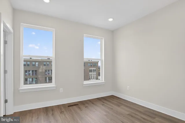 a view of a room with wooden floor and window