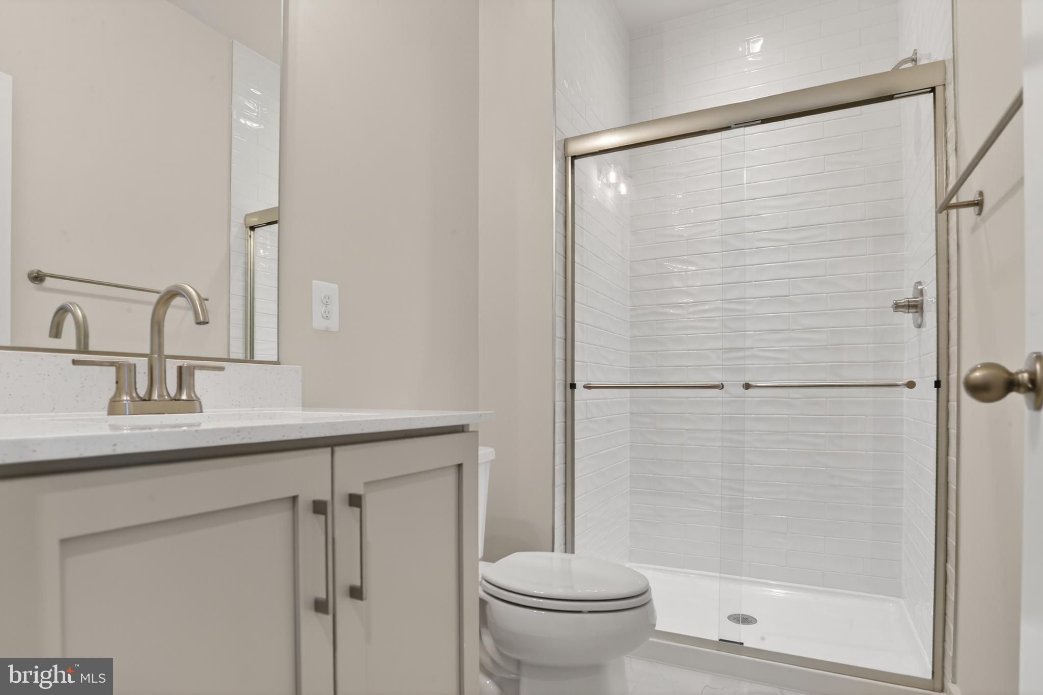 2710 Light Street Baltimore, MD 21230 - Photo 22 of 25 a bathroom with a shower sink vanity and toilet