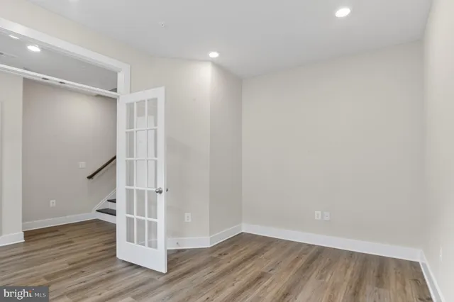 a view of a hallway with wooden floor and entryway