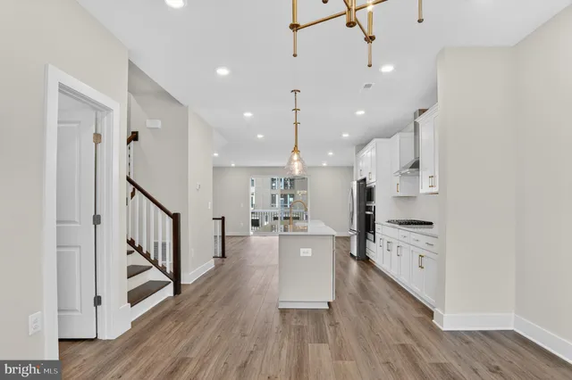 a view of a kitchen with wooden floor and a window