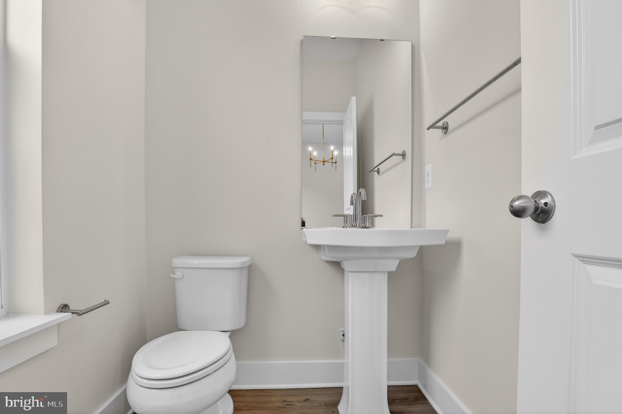 2710 Light Street Baltimore, MD 21230 - Photo 10 of 25 a bathroom with a toilet sink and mirror