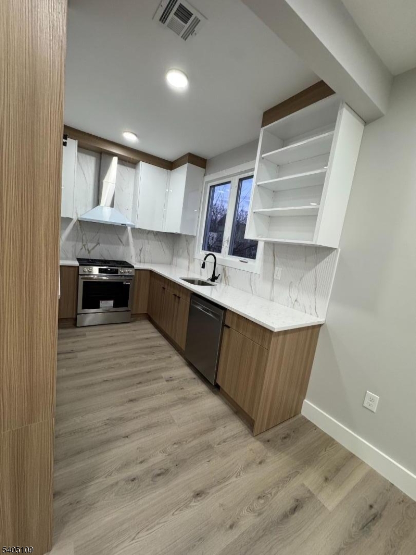 a kitchen with stainless steel appliances granite countertop a sink counter space and cabinets