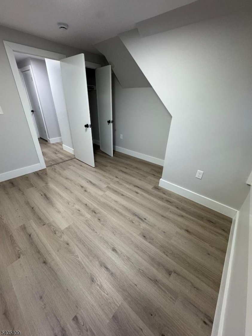 859 South 16th Street, Unit 2 Newark, NJ 07108 - Photo 13 of 14 a view of an empty room with wooden floor
