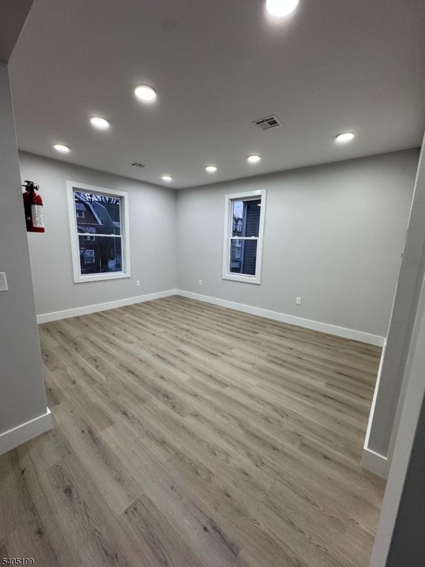 859 South 16th Street, Unit 2 Newark, NJ 07108 - Photo 2 of 14 an empty room with wooden floor and windows
