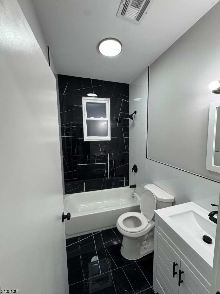 859 South 16th Street, Unit 2 Newark, NJ 07108 - Photo 5 of 14 a bathroom with a sink a toilet and mirror