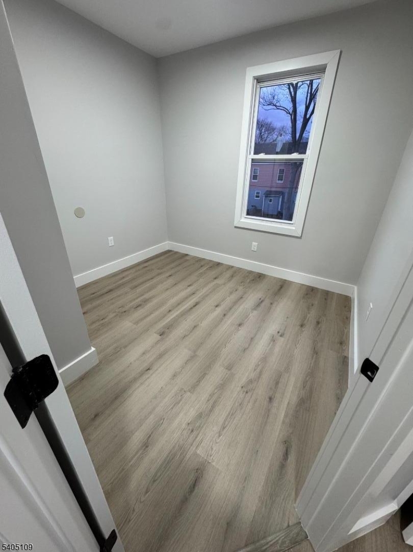 859 South 16th Street, Unit 2 Newark, NJ 07108 - Photo 8 of 14 a view of an empty room with wooden floor