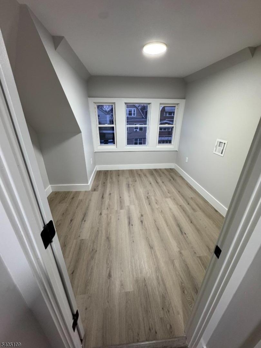 859 South 16th Street, Unit 2 Newark, NJ 07108 - Photo 9 of 14 wooden floor in an empty room with a window