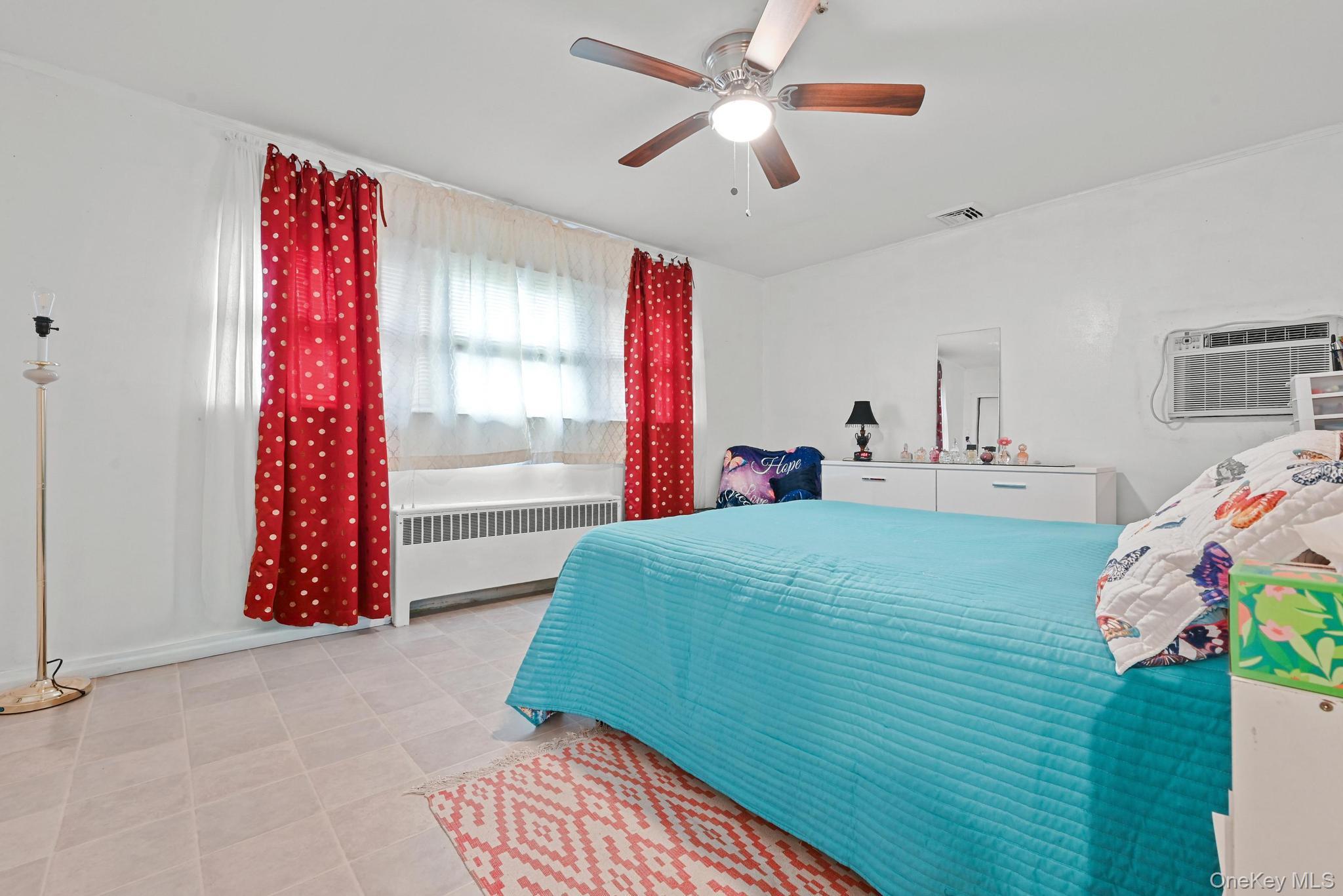 2225 Leighton Road Elmont, NY 11003 - Photo 15 of 26 a bedroom with a bed and a window