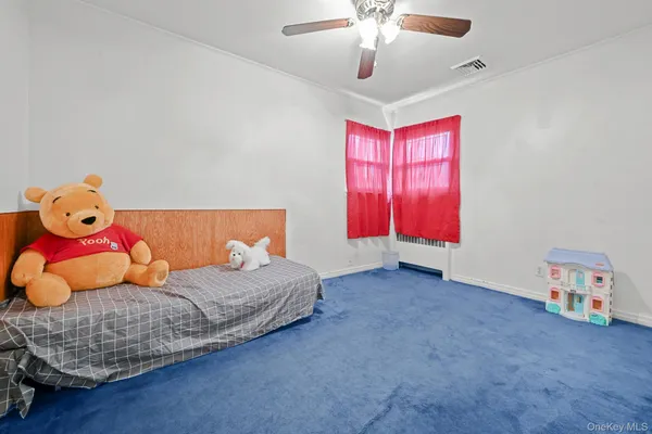a living room with a bed and a flat screen tv
