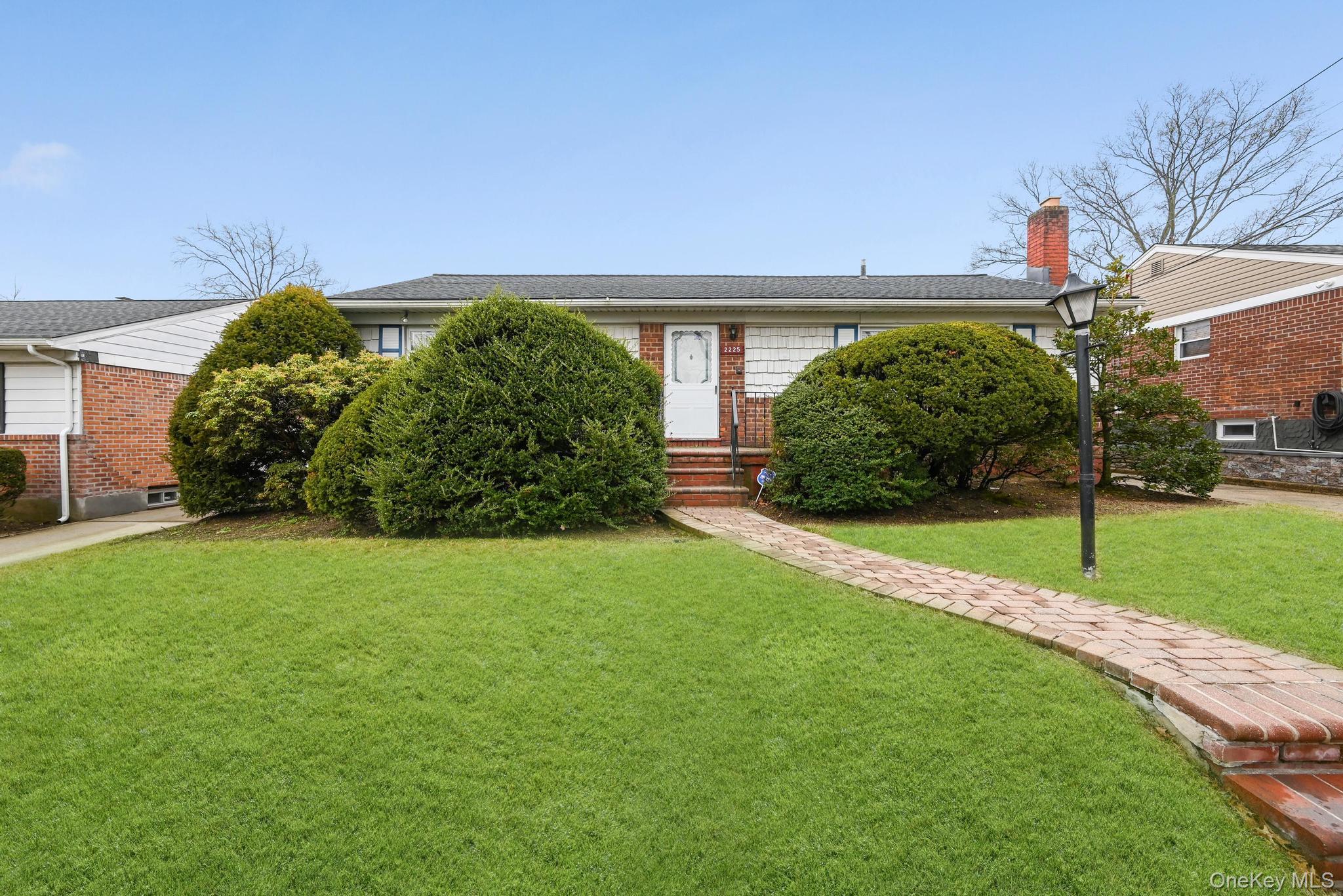 2225 Leighton Road Elmont, NY 11003 - Photo 2 of 26 a front view of a house with garden