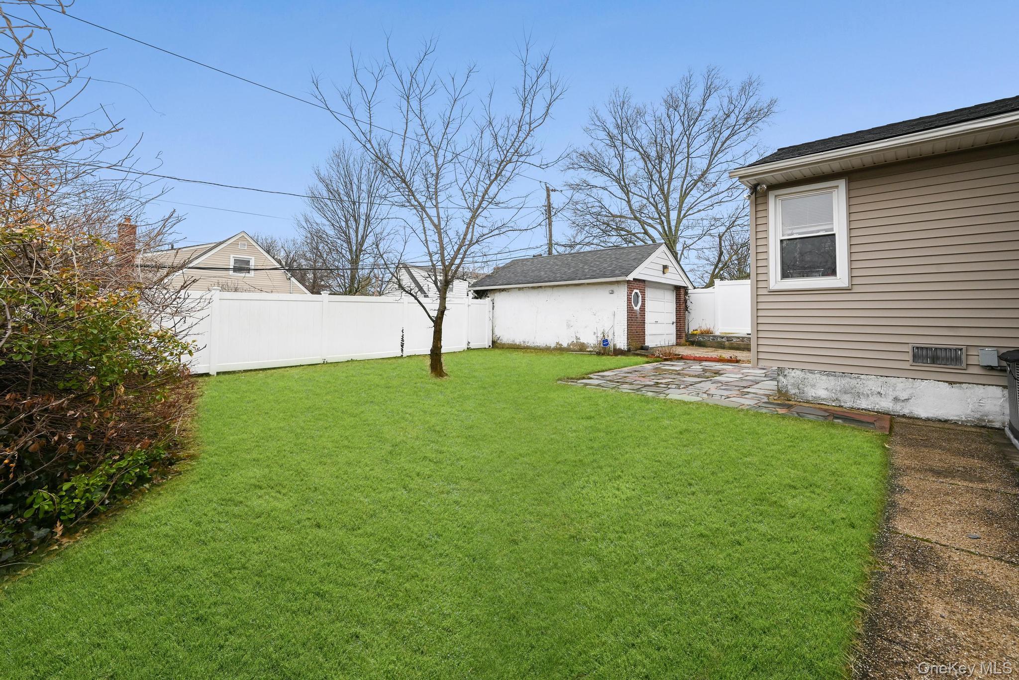 2225 Leighton Road Elmont, NY 11003 - Photo 22 of 26 a view of a backyard with a garden