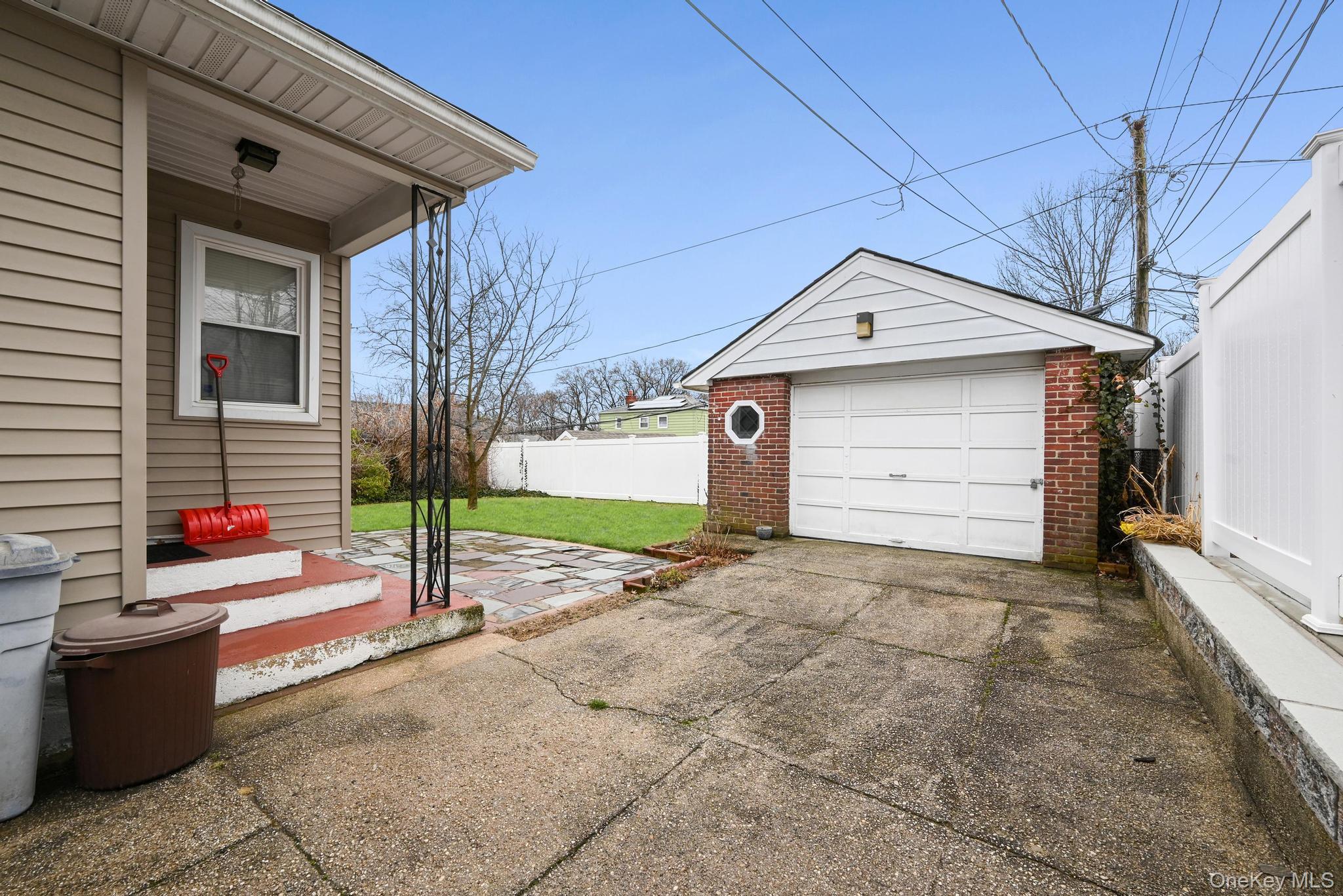 2225 Leighton Road Elmont, NY 11003 - Photo 25 of 26 a front view of a house with a garage