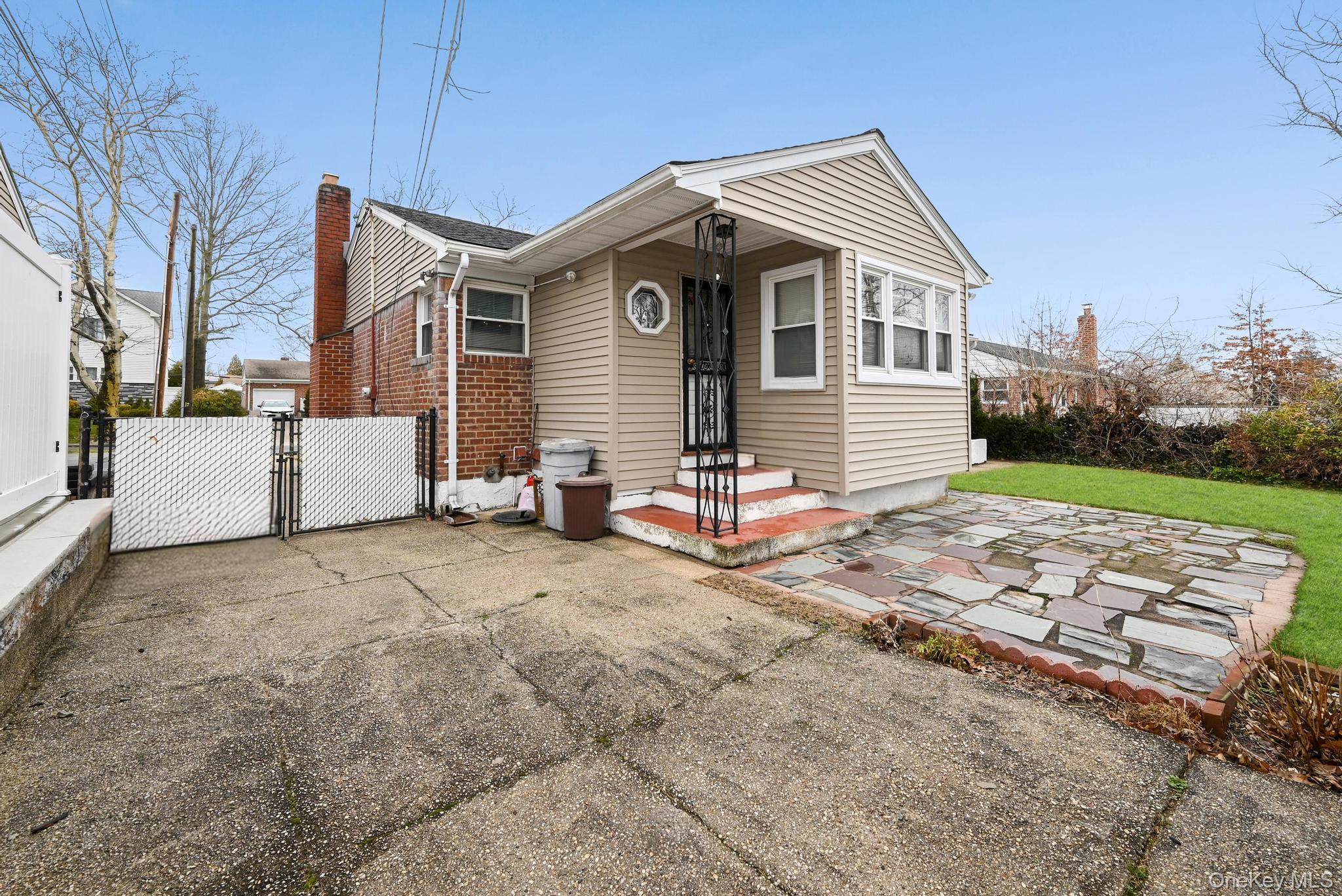 2225 Leighton Road Elmont, NY 11003 - Photo 26 of 26 a front view of a house with a yard
