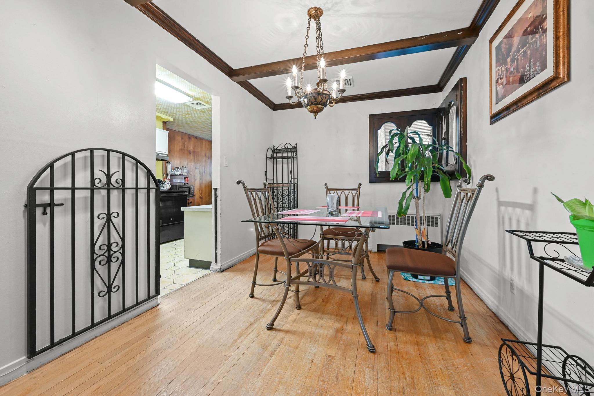 2225 Leighton Road Elmont, NY 11003 - Photo 9 of 26 a view of a dining room with furniture a chandelier and wooden floor