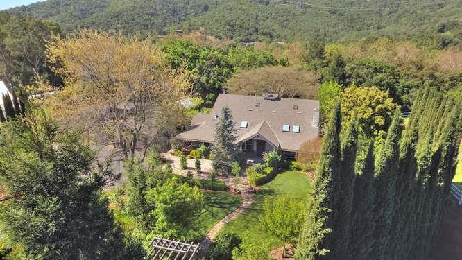 an aerial view of a house with a yard