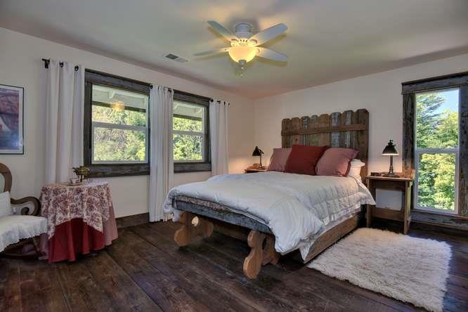 12455 Watsonville Road Gilroy, CA 95020 - Photo 29 of 49 a bedroom with a large bed and a chandelier