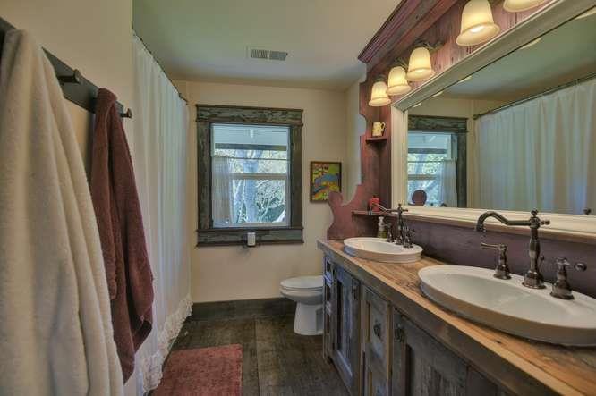 12455 Watsonville Road Gilroy, CA 95020 - Photo 31 of 49 a bathroom with double vanity sink a mirror and a toilet