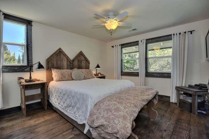 12455 Watsonville Road Gilroy, CA 95020 - Photo 32 of 49 a bedroom with a bed and a chandelier