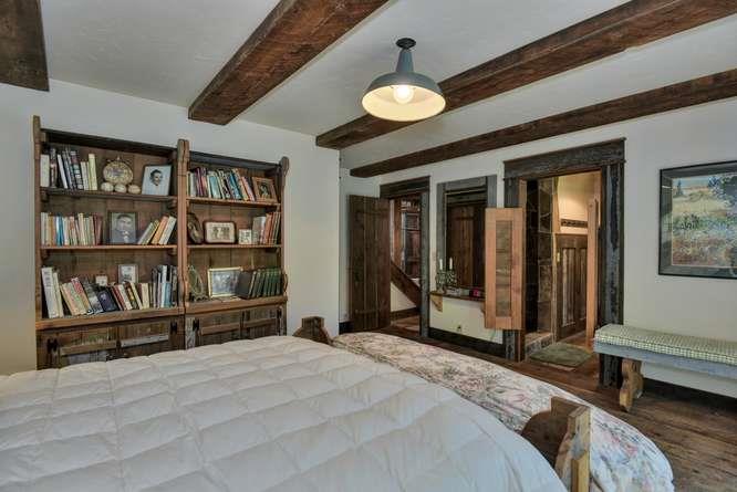 12455 Watsonville Road Gilroy, CA 95020 - Photo 33 of 49 a bedroom with a large bed and a chandelier