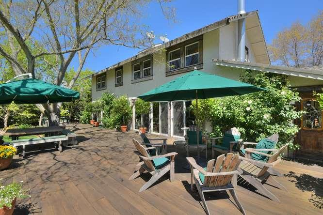 12455 Watsonville Road Gilroy, CA 95020 - Photo 40 of 49 a view of a patio with a table and chairs under an umbrella