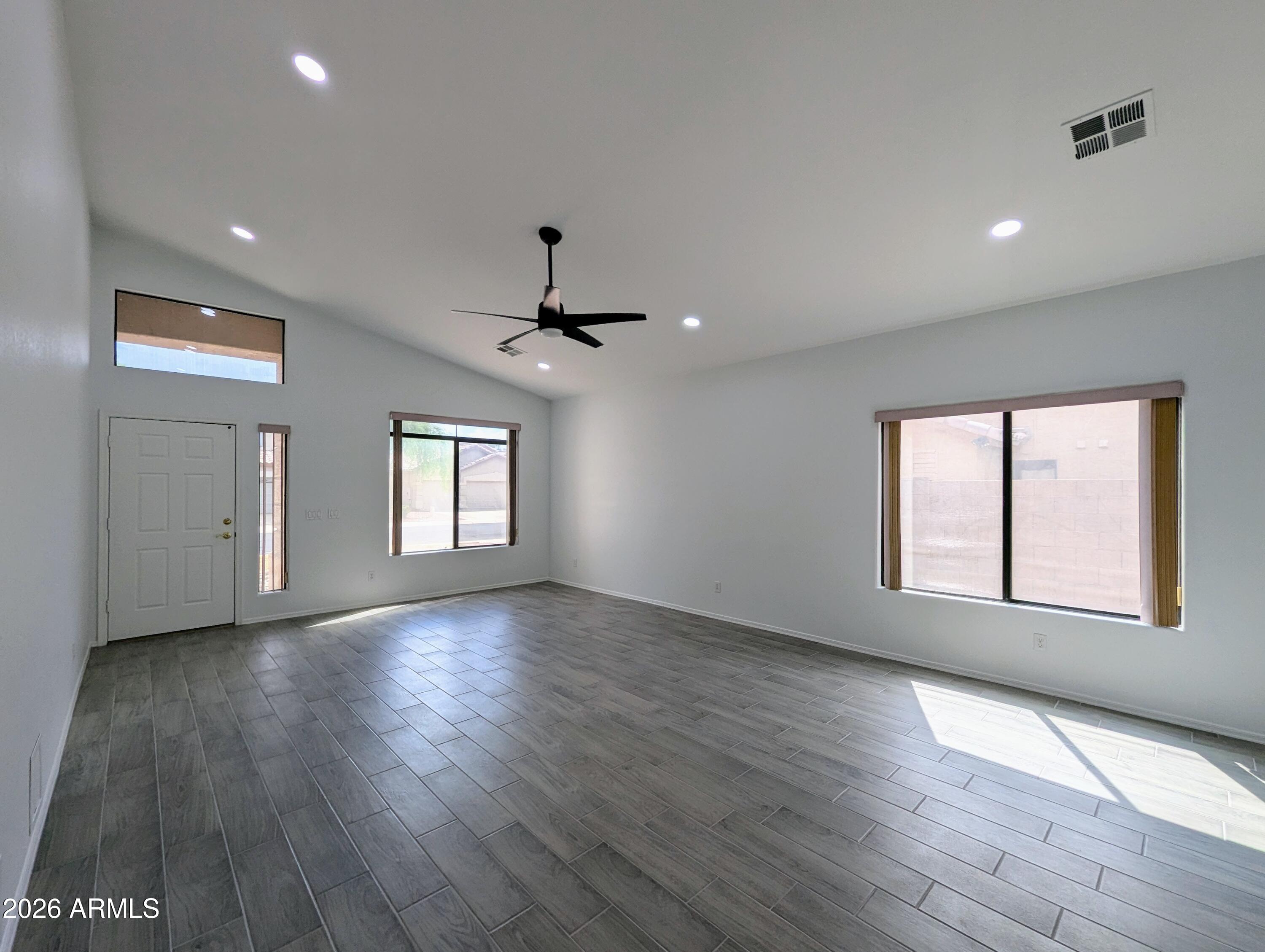 5424 West Wagoner Road Glendale, AZ 85308 - Photo 4 of 37 a view of an empty room with wooden floor and a window