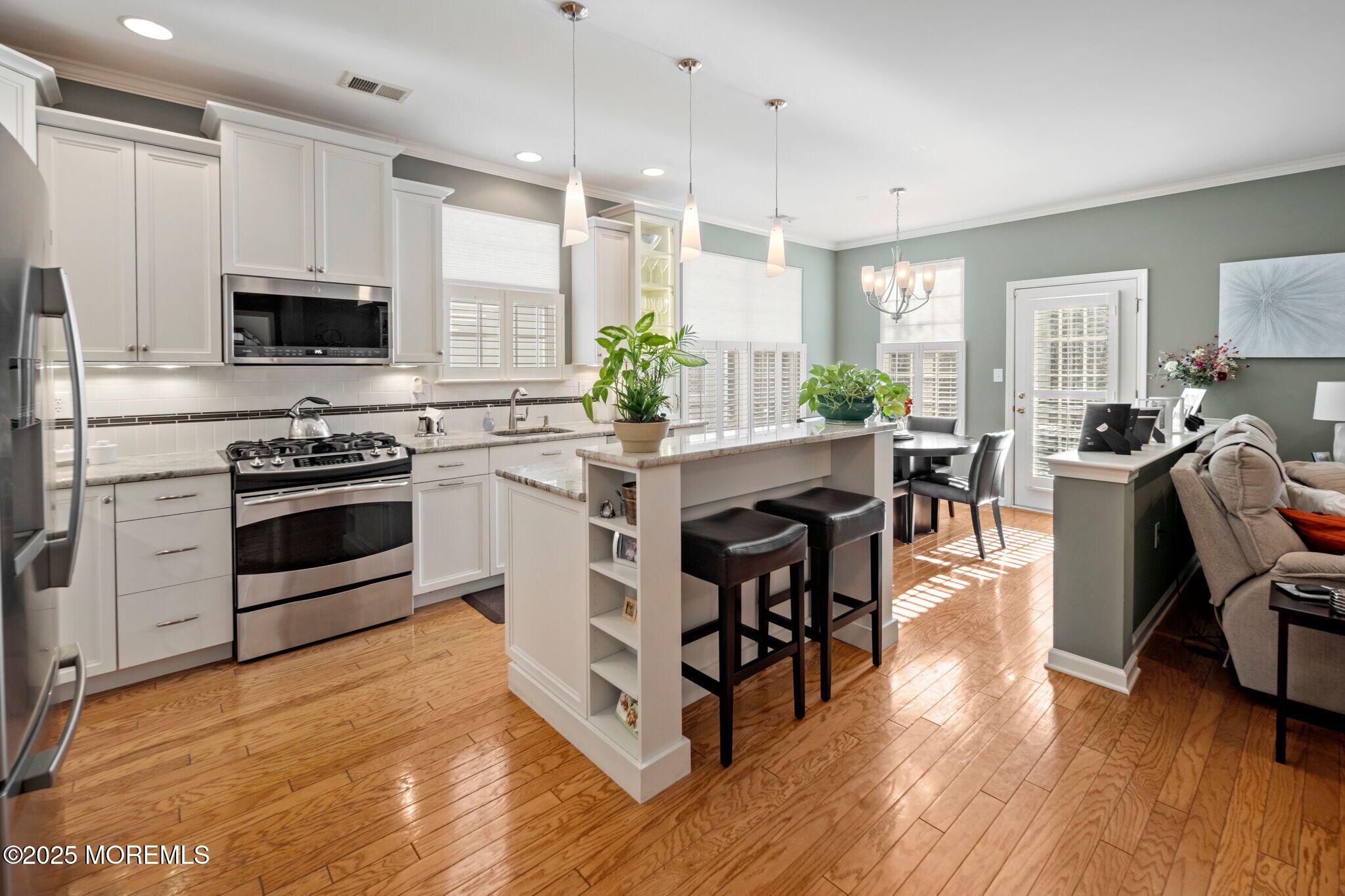 87 Pond View Circle Barnegat, NJ 08005 - Photo 15 of 66 a kitchen with stainless steel appliances a table chairs sink and stove top oven