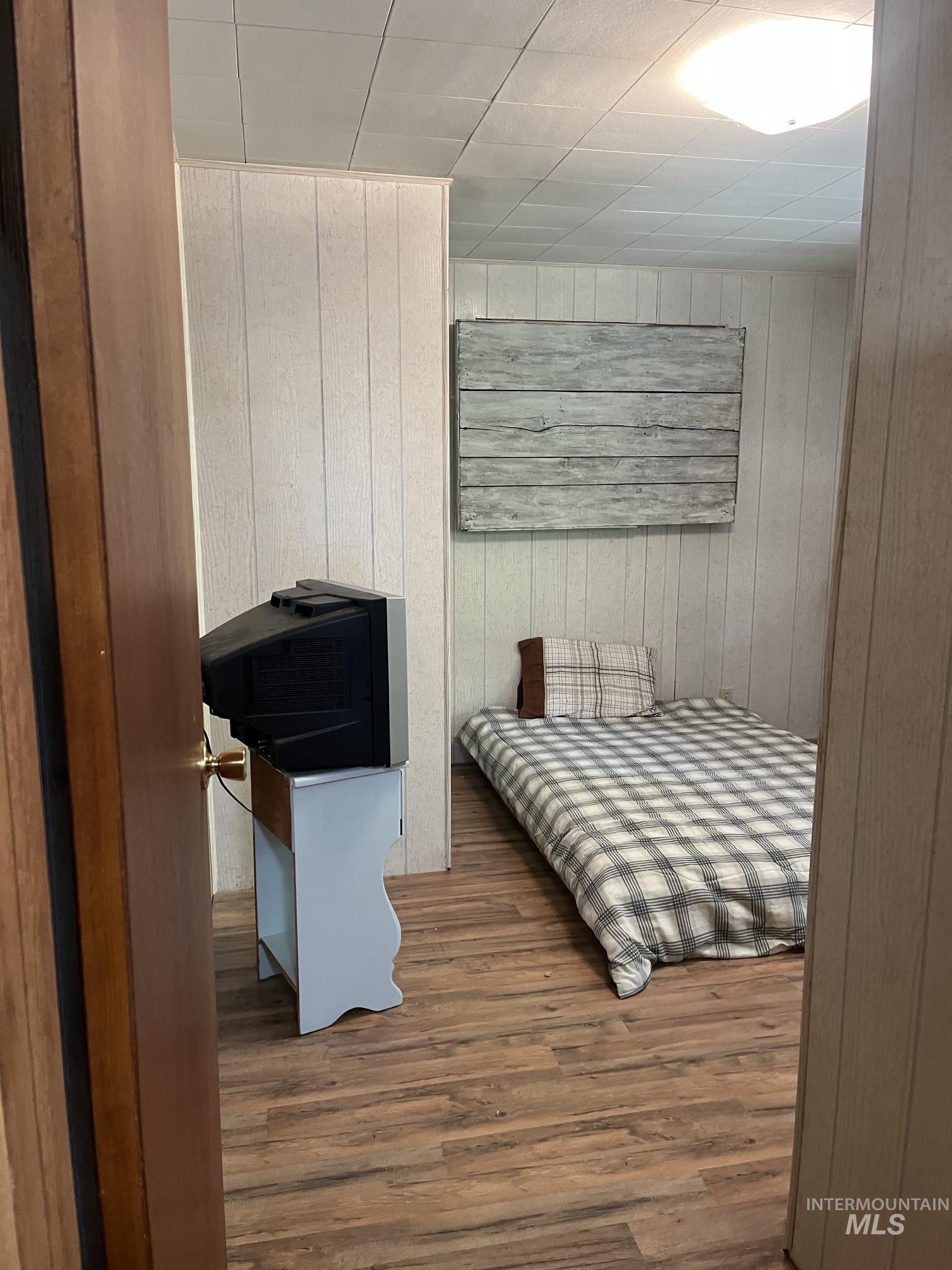 39 Mayflower Mine Road Placerville, ID 83666 - Photo 35 of 36 Wood-finish flooring throughout, complemented by vertical paneling on the walls and a paneled ceiling
