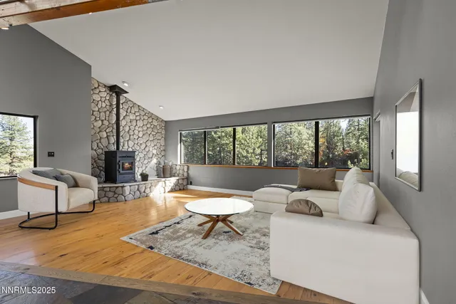 a view of a living room with a table and chairs