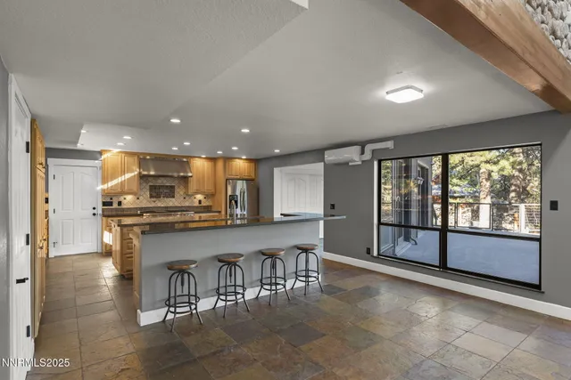 a kitchen with stainless steel appliances granite countertop a sink a stove and a refrigerator