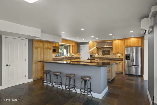 a kitchen with granite countertop a stove and a refrigerator