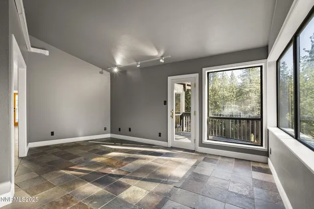 a view of a livingroom with a ceiling fan and window