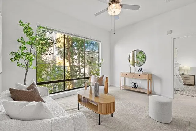 a living room with furniture and a potted plant