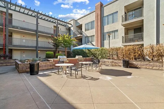 a view of a patio with dining table and chairs