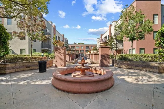a view of a house with fountain in front of building