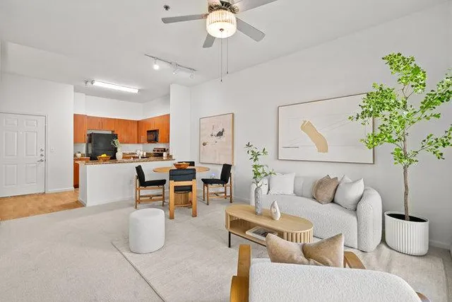 a living room with furniture and a chandelier
