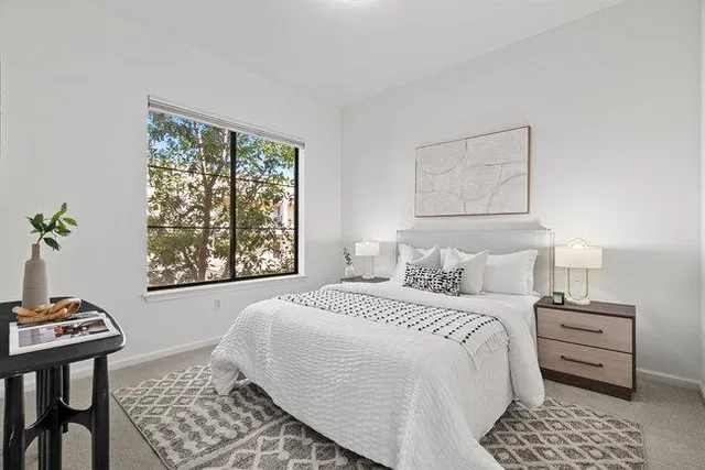 a bedroom with a bed and a window