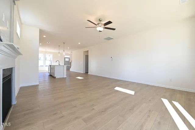 a bedroom with a large bed a flat screen tv and couches