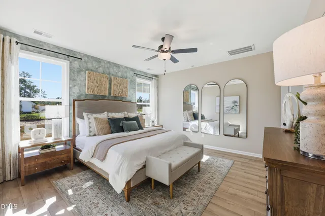 a bedroom with a bed and painting on the wall