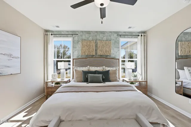 a bedroom with a bed and a large window