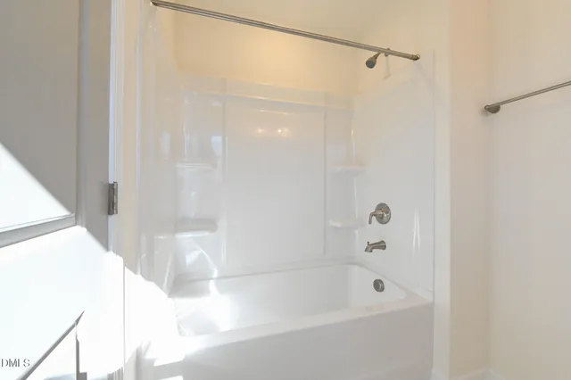 a view of large house with a yard and car parked