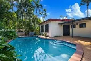 a view of a house with pool and sitting area