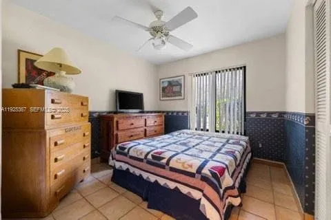 a bed room with a bed and a large window