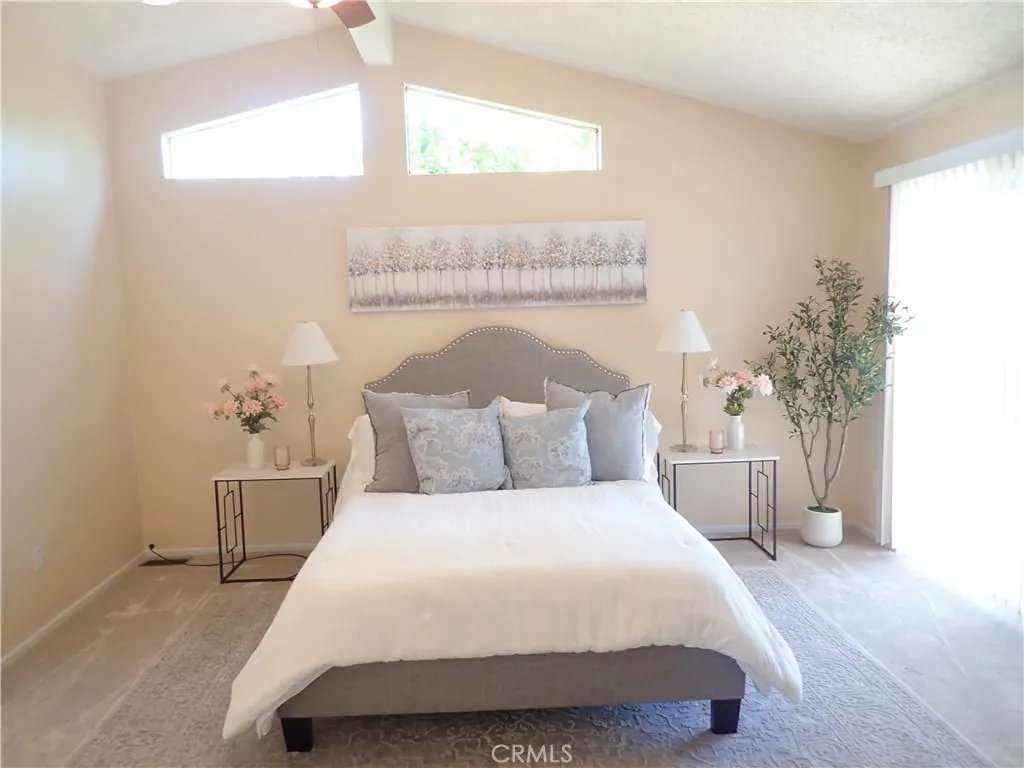 27250 Murrieta Road, Unit 75 Menifee, CA 92586 - Photo 11 of 29 a bedroom with a large bed and a chandelier