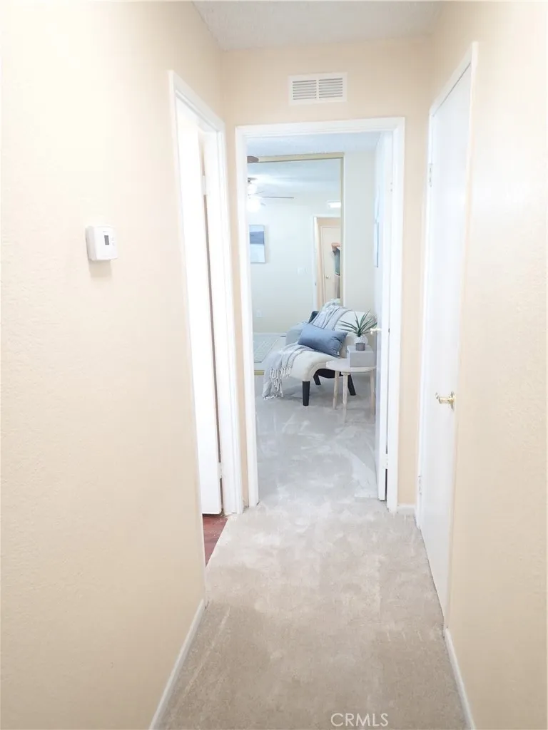 27250 Murrieta Road, Unit 75 Menifee, CA 92586 - Photo 18 of 29 a view of a hallway with couch