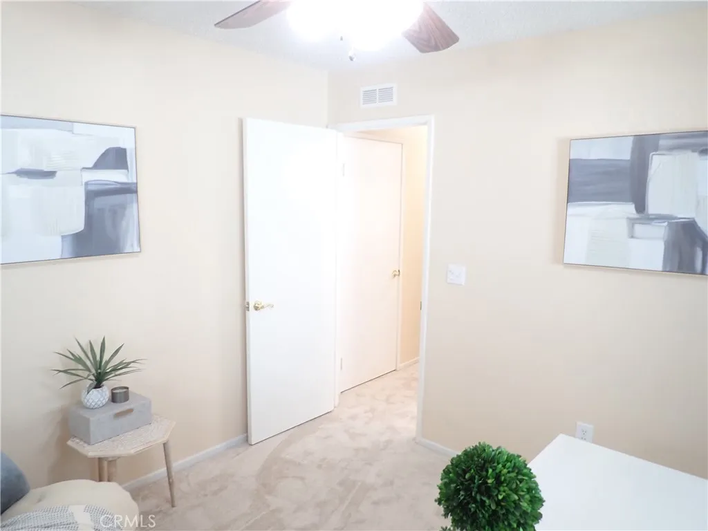 27250 Murrieta Road, Unit 75 Menifee, CA 92586 - Photo 21 of 29 a bathroom with a shower curtain and a toilet