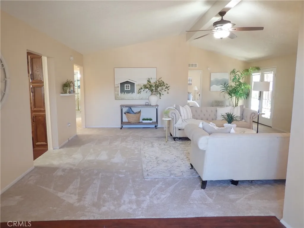 27250 Murrieta Road, Unit 75 Menifee, CA 92586 - Photo 3 of 29 a living room with furniture and a chandelier